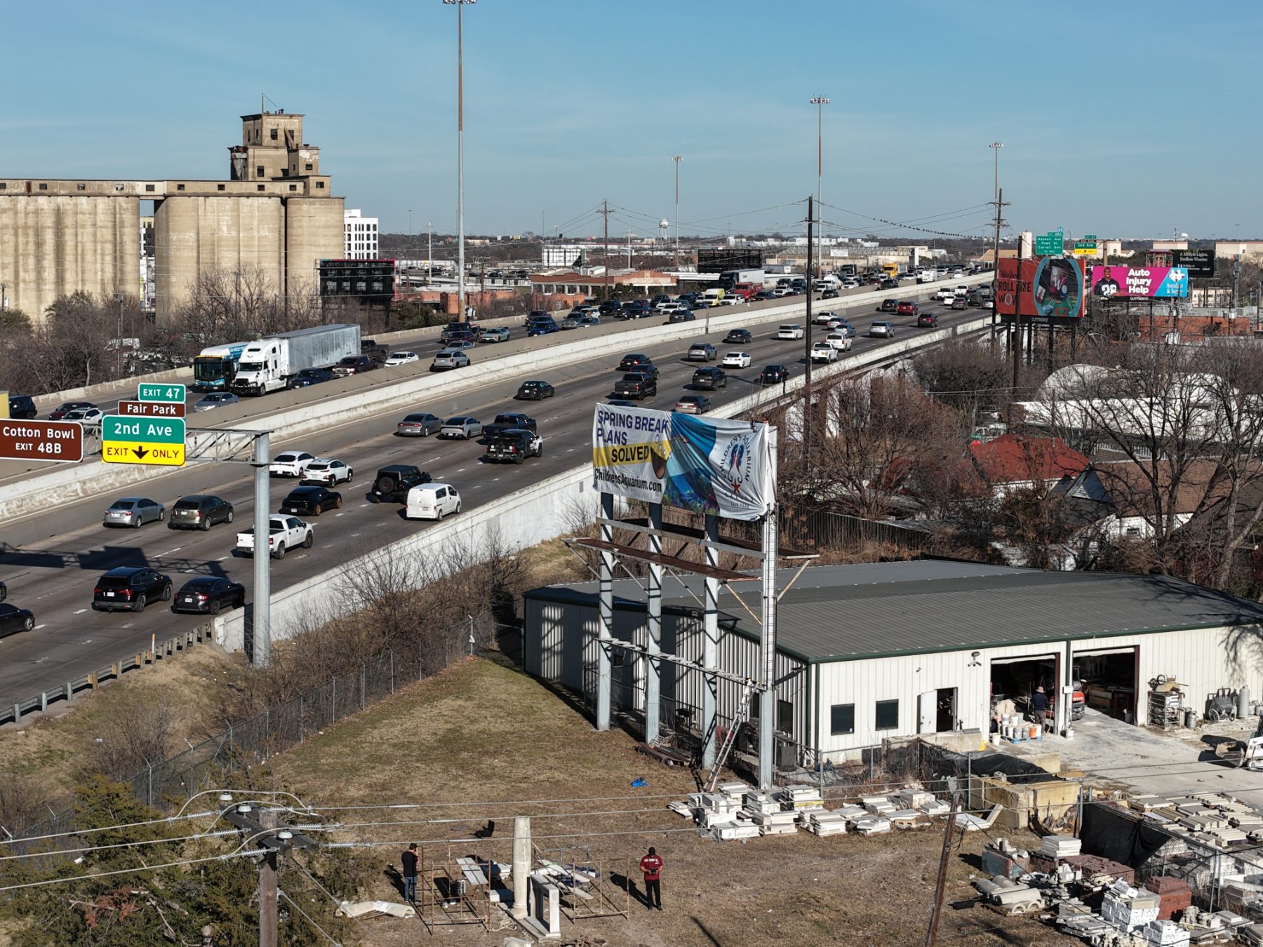Children’s Aquarium Dallas billboard over I-30 traffic, drone photo 3