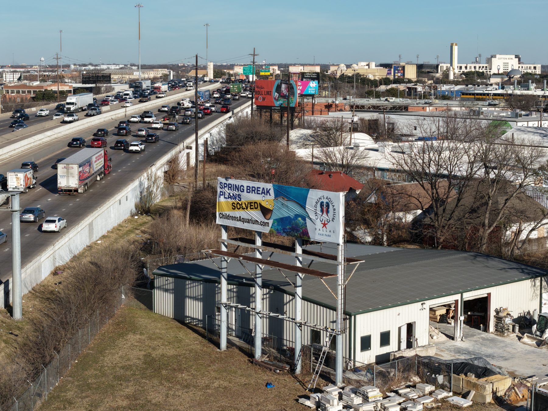 Children’s Aquarium Dallas billboard over I-30 traffic, drone photo 4
