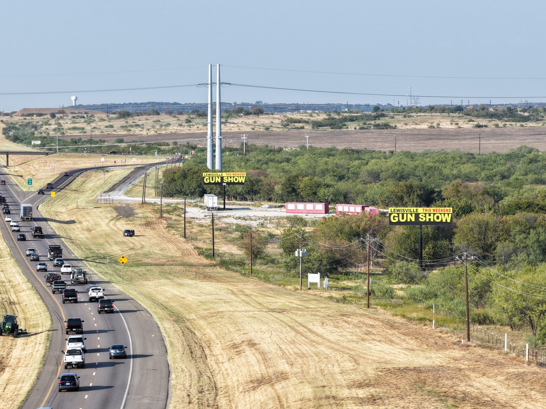 Lewisville Gun Show ads on two digital billboards along the highway
